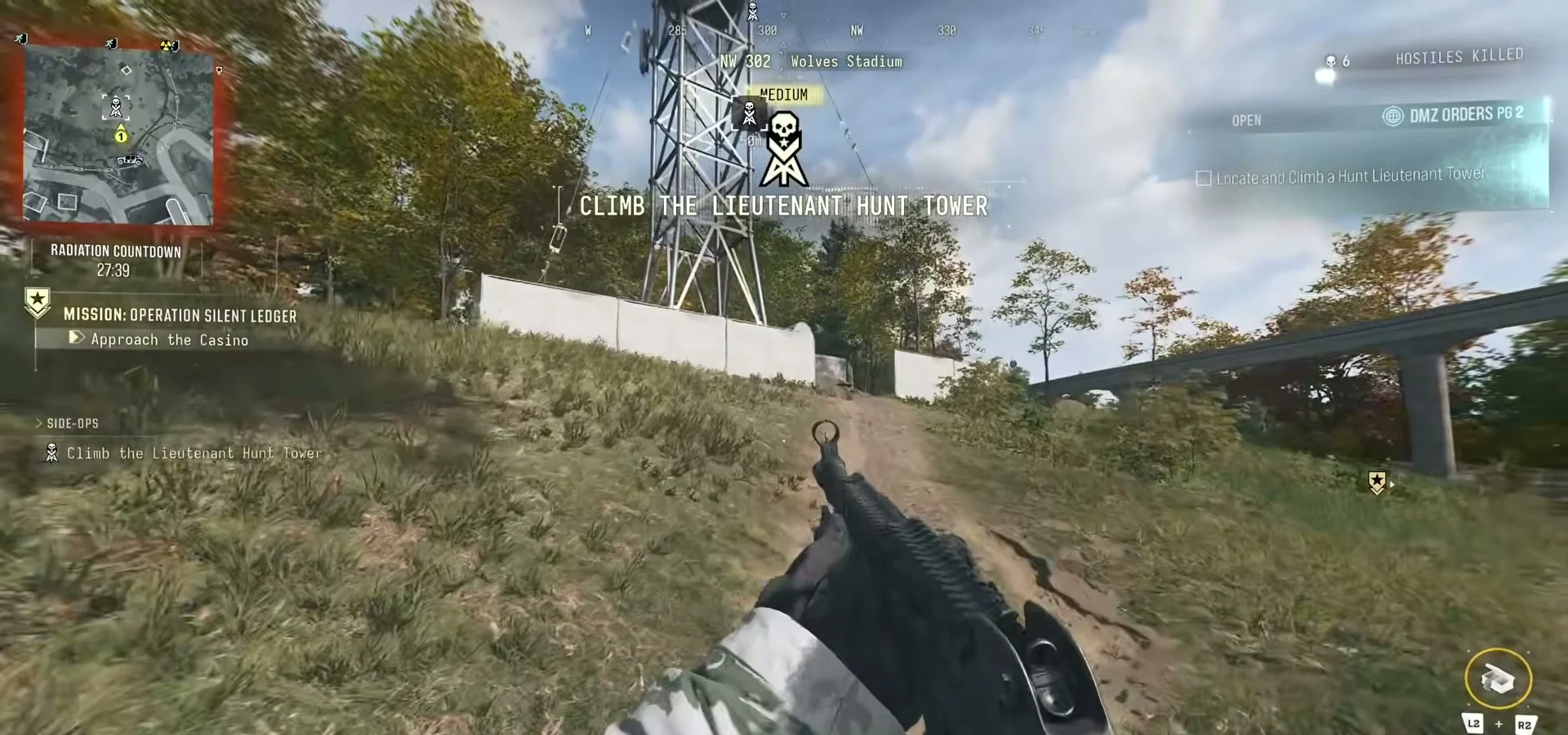 Uphill approach to the Lieutenant Hunt tower beside Wolves Stadium, with its skull marker and climb prompt